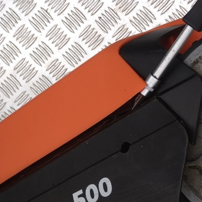 6 Push the bottom latch with a finger (not visible here) while lifting the cover